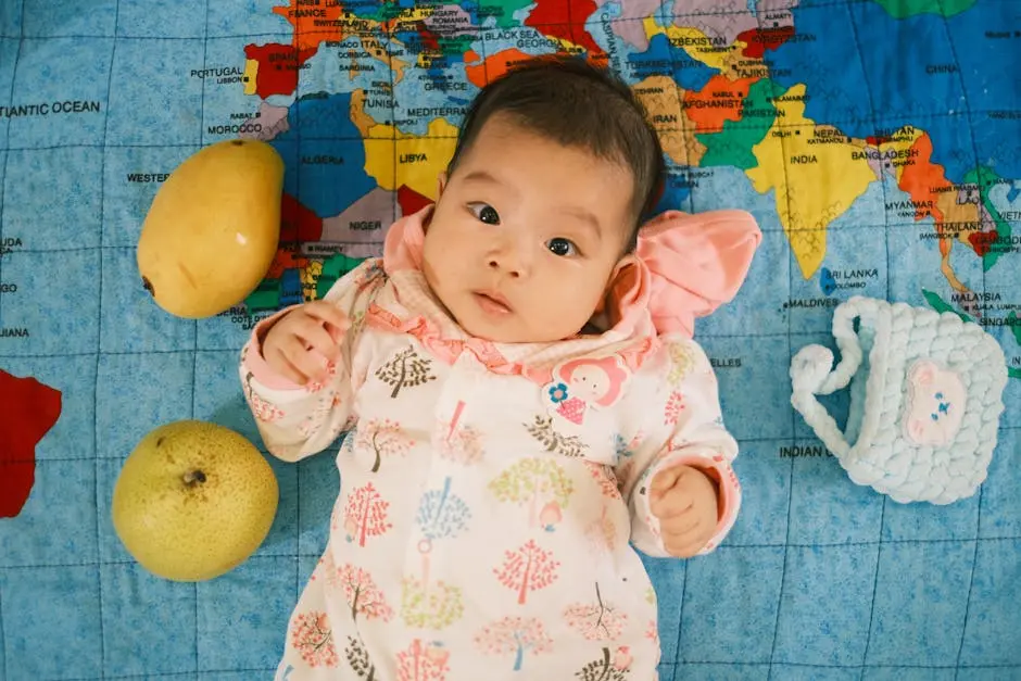 Adorable Baby Lying on World Map with Fruits