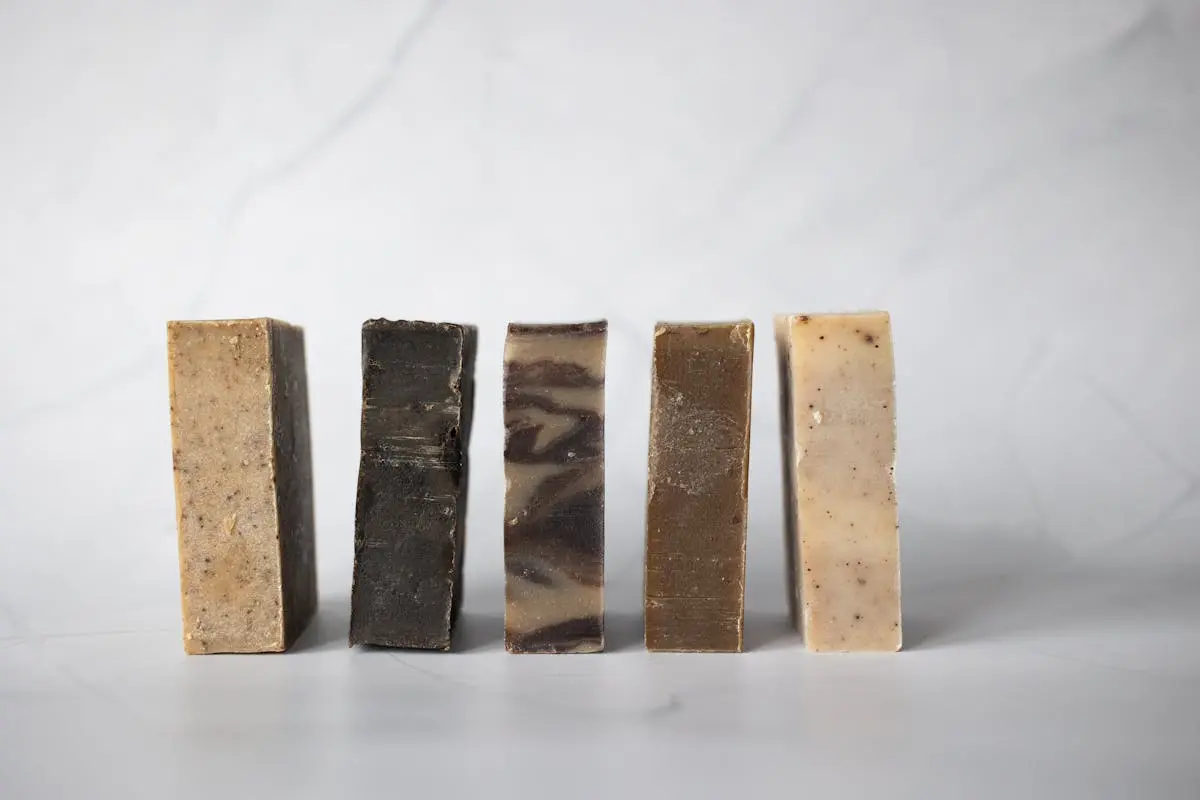 Set of handmade soaps placed on marble surface