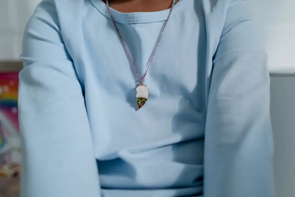 A Person Wearing a Necklace with a Pendant