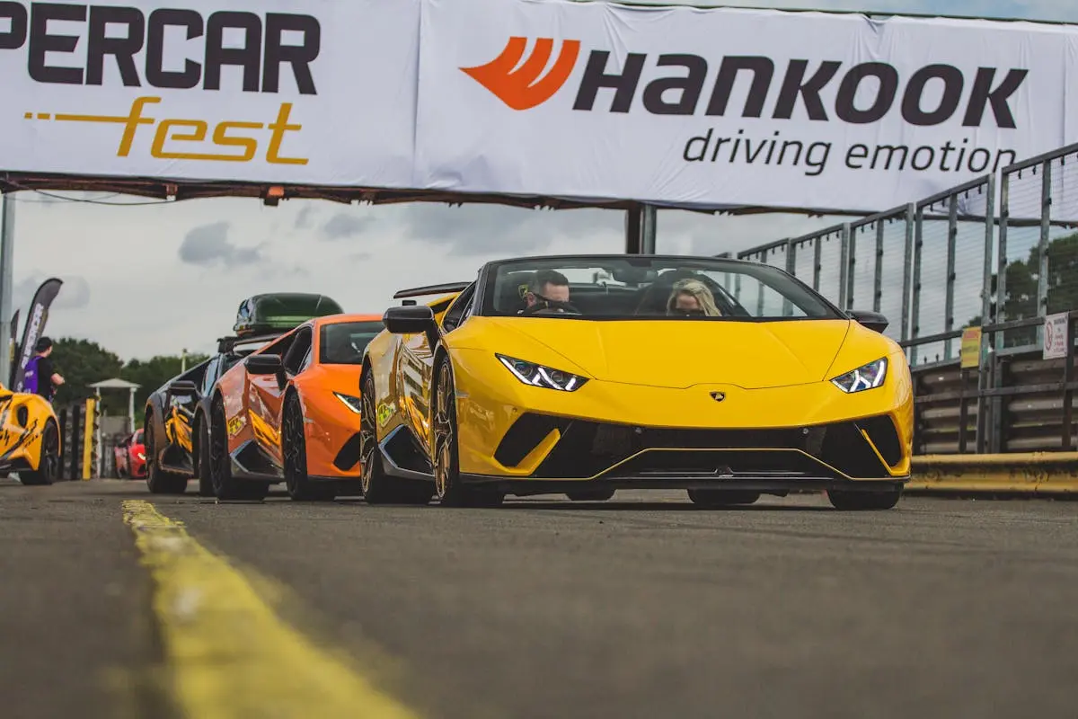 A group of cars driving on a track