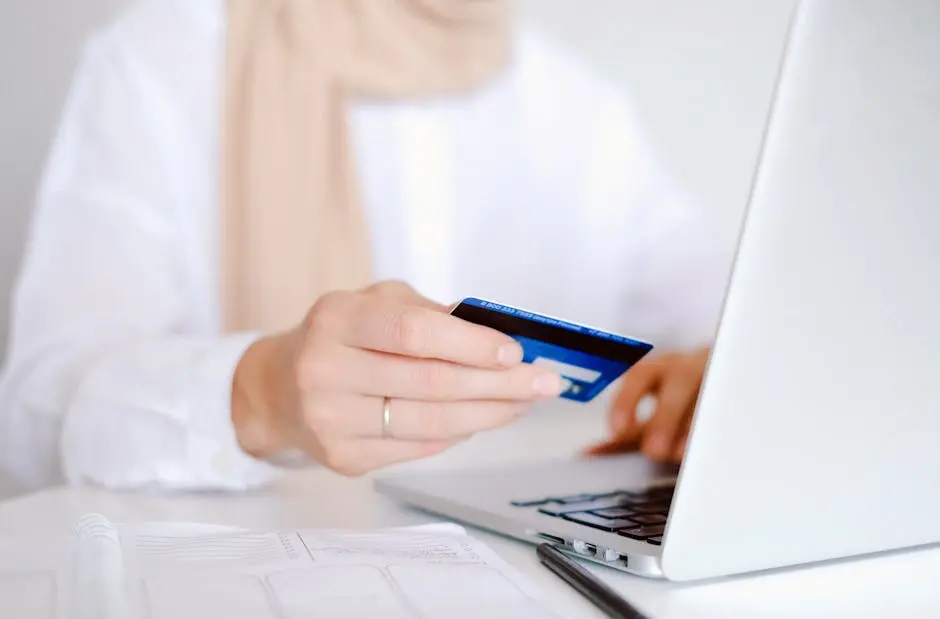 Person in White Long Sleeve Shirt Holding Credit Card