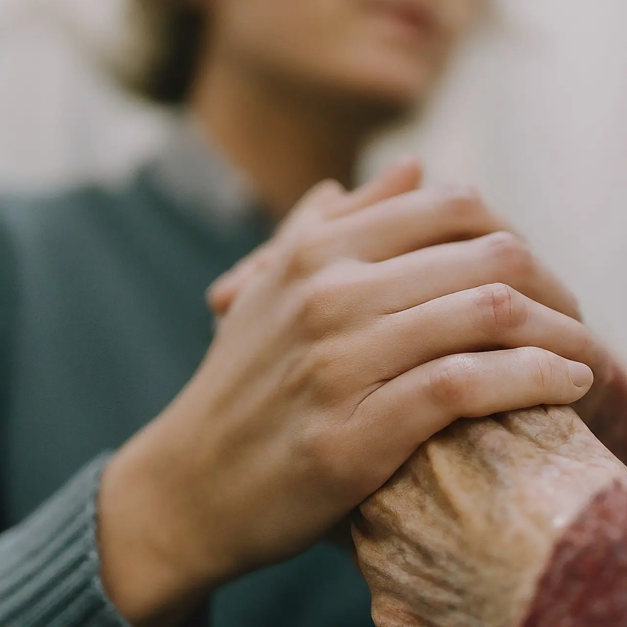 Medical professional gently holding an elderly patient’s hand for support. 35mm stock photo