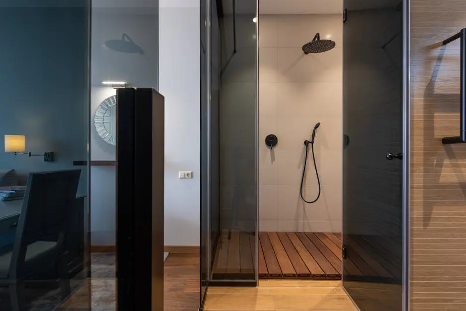 Elegant contemporary bathroom featuring a glass-walled shower with wooden flooring.