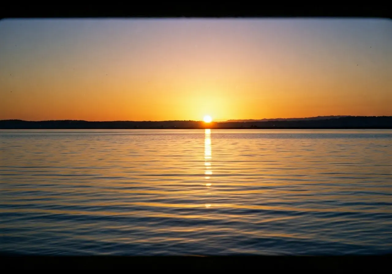 A serene sunset over a calm, tranquil ocean. 35mm stock photo