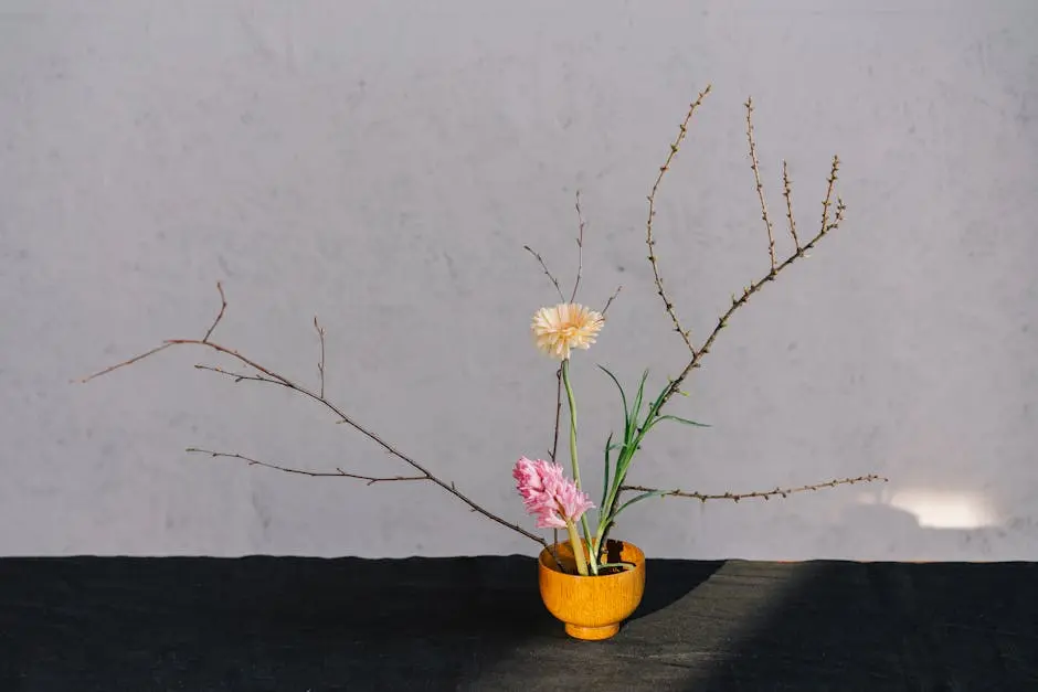 A serene minimalist floral arrangement in a wooden vase with branches and blooms.