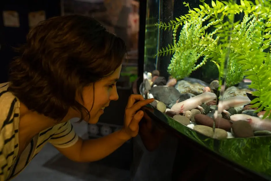 Woman in a Striped Shirt Pointing on an Aquarium