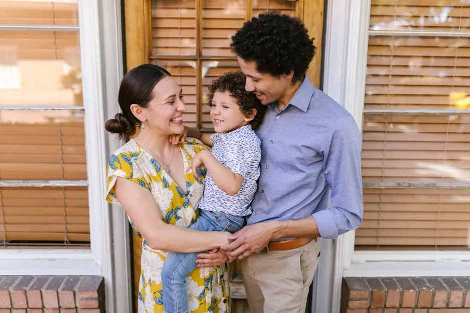 Parents Carrying a Boy Standing Near Glass Windows with Blinds