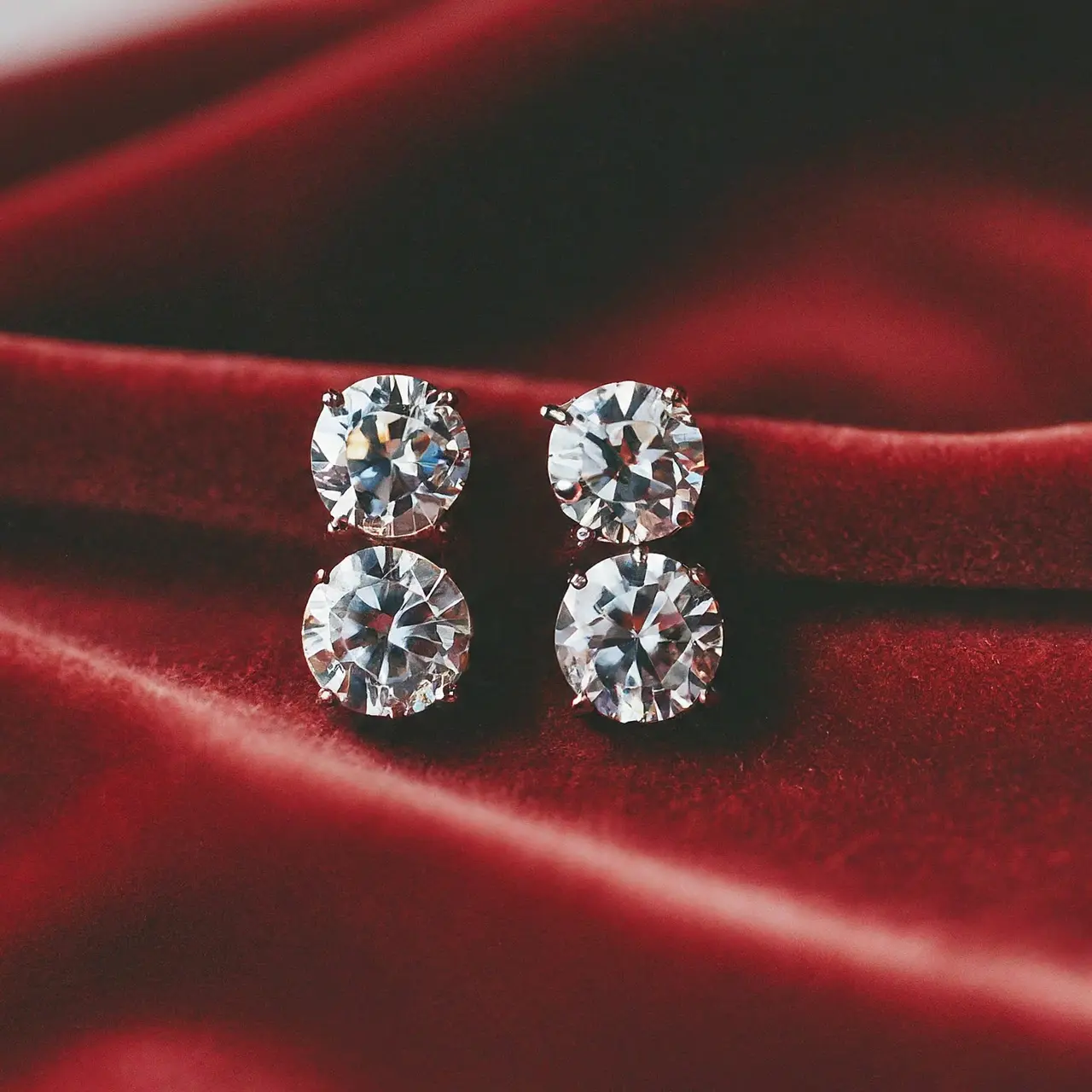 Close-up of man-made diamond earrings on a velvet background. 35mm stock photo