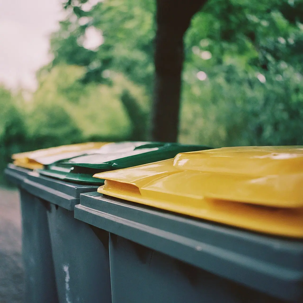 Recycling bins filled with separated waste materials. 35mm stock photo