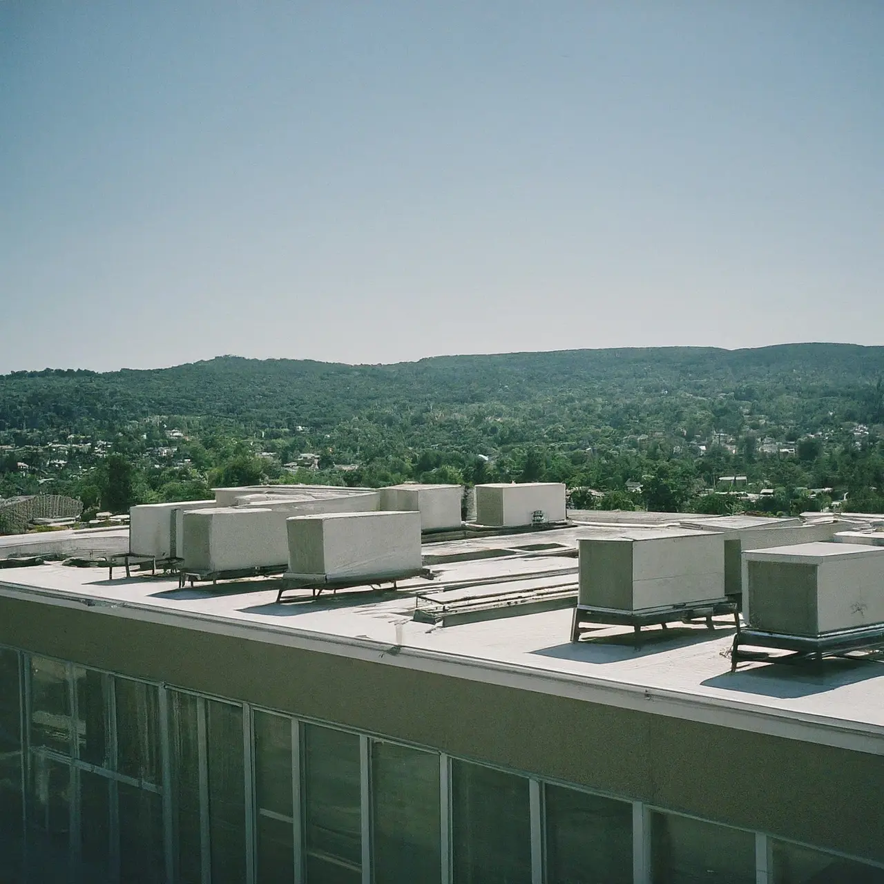 A modern commercial building with HVAC units on the roof. 35mm stock photo