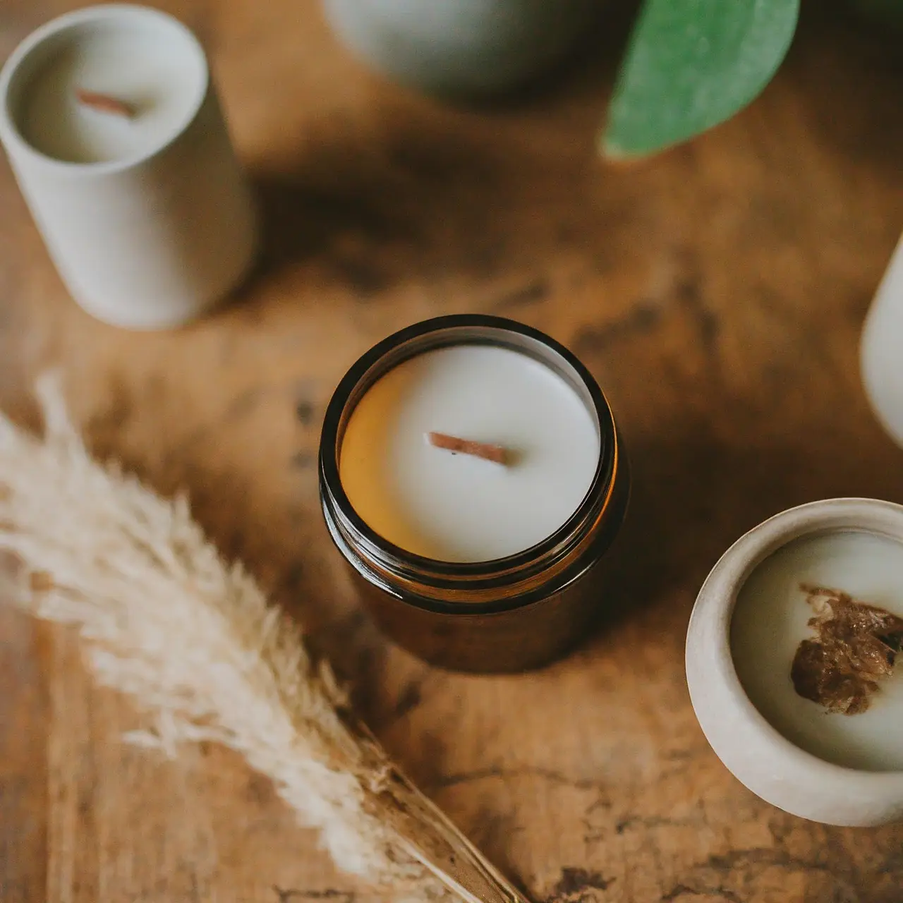 Assorted essential oil candles on a rustic wooden surface. 35mm stock photo