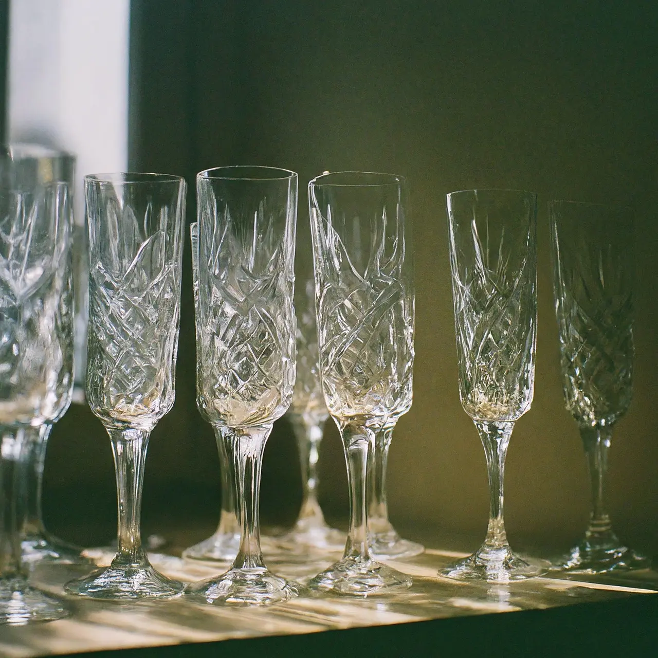 Crystal highball glasses on a shelf with backlighting. 35mm stock photo