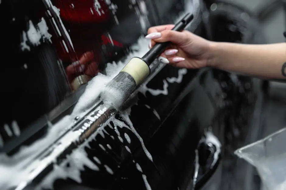 A Close-Up Shot of a Person Brushing a Car