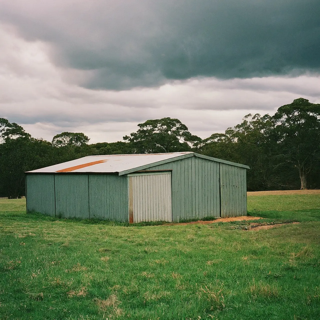 Australian made sheds under a bright, stormy sky in Sydney. 35mm stock photo