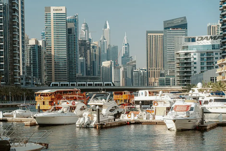 A stunning view of Dubai Marina with modern skyscrapers and yachts under a clear sky.