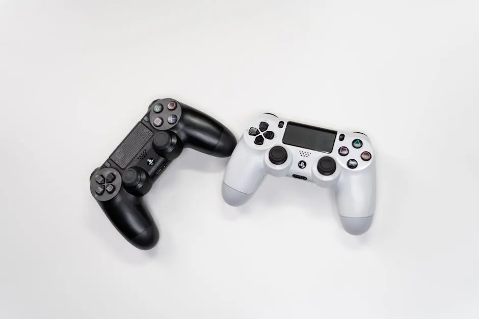 Flat lay of black and white gaming controllers against a white backdrop, perfect for gaming enthusiasts.