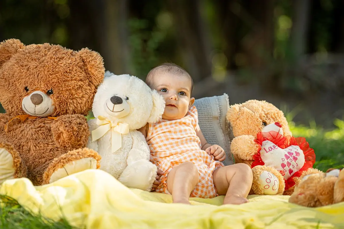 Little Girl Sitting by Soft Stuffed Animals Teddy Bears on Yellow Blanket at Picnic