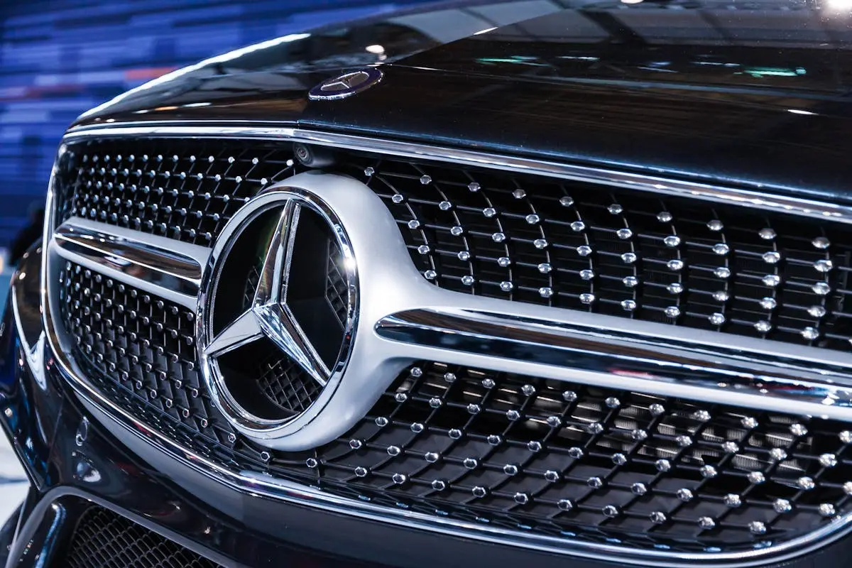 Detailed view of the iconic Mercedes Benz emblem showcasing luxury and design excellence.