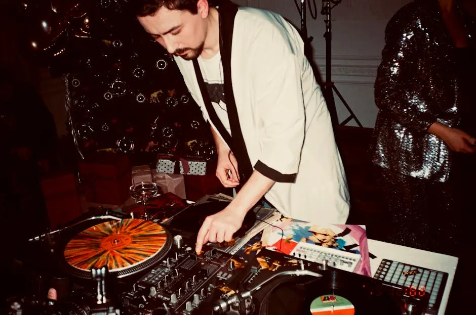 A DJ mixing records at a lively indoor party, surrounded by festive decorations.