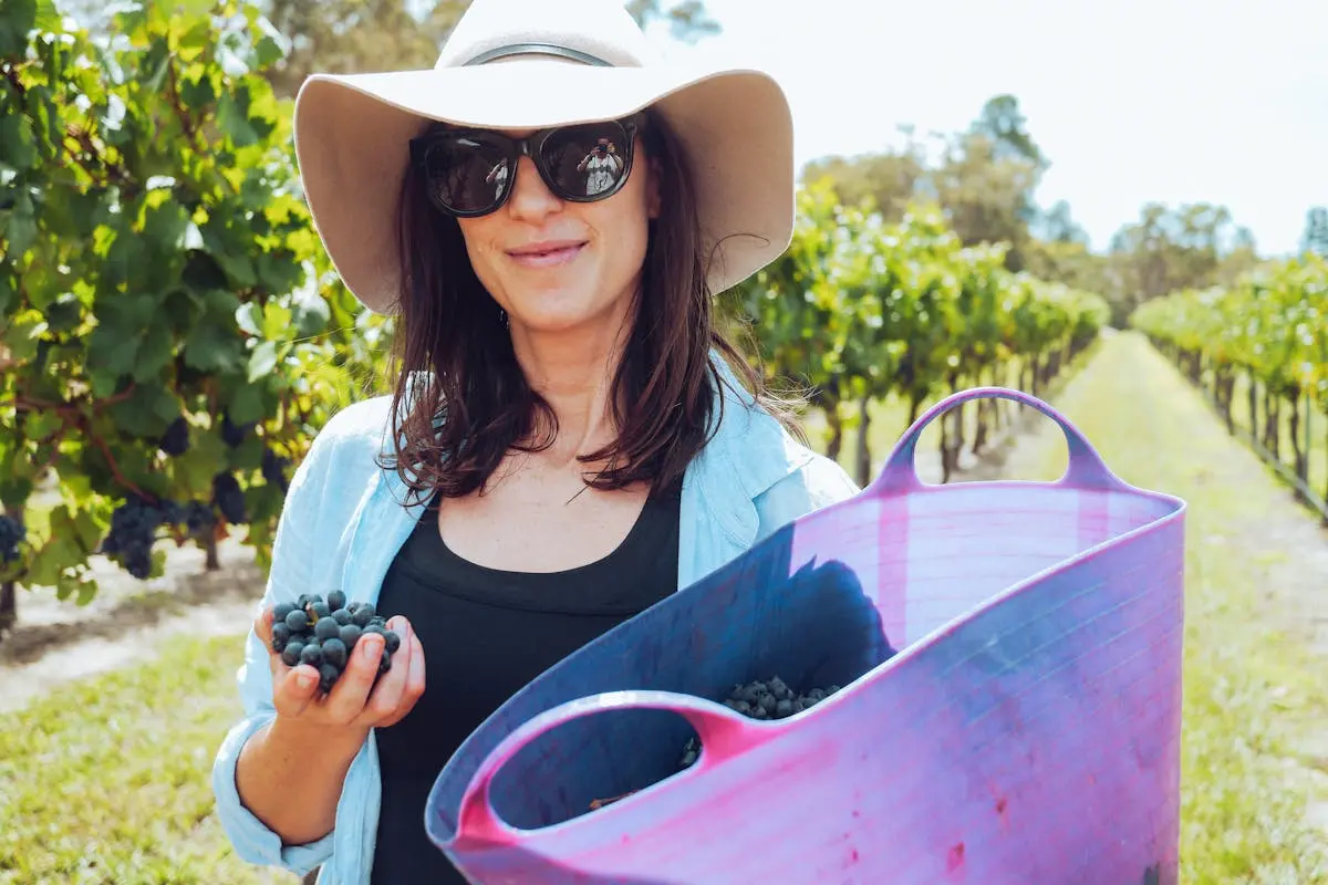 Woman Holding a Bucket of Grapes