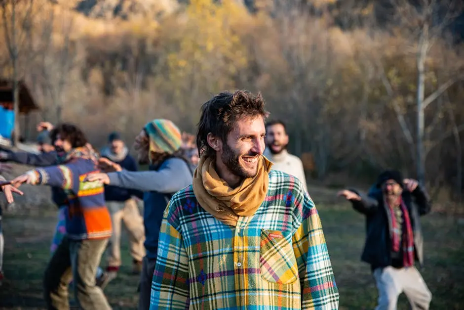 Group of adults joyfully dancing outdoors in autumn