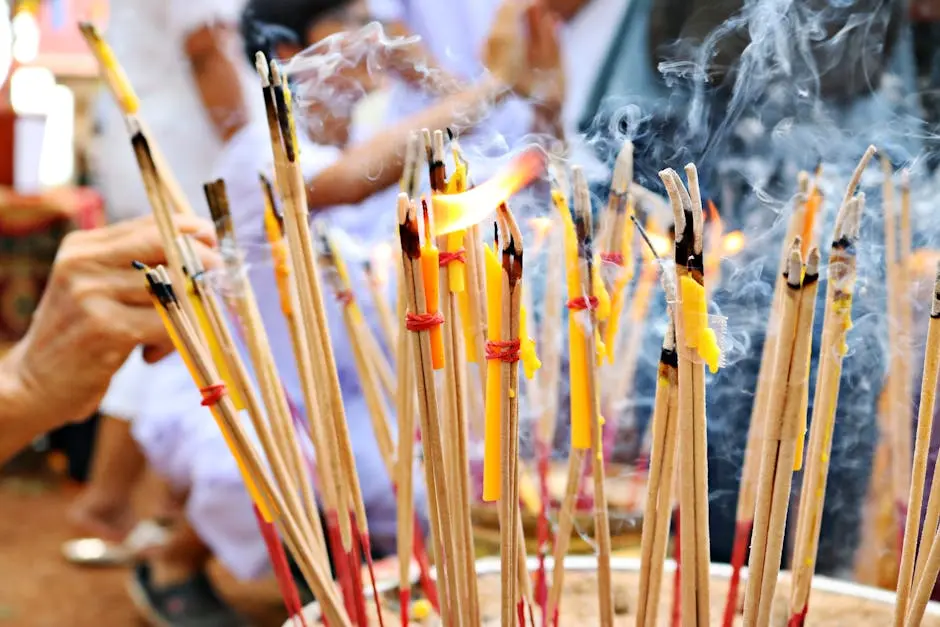 A close-up of incense sticks burning during a Buddhist ritual, capturing the essence of culture and tradition.