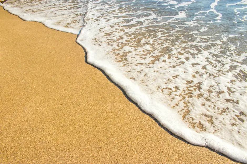 Peaceful beach scene showing sand meeting ocean waves in Puntarenas, Costa Rica.