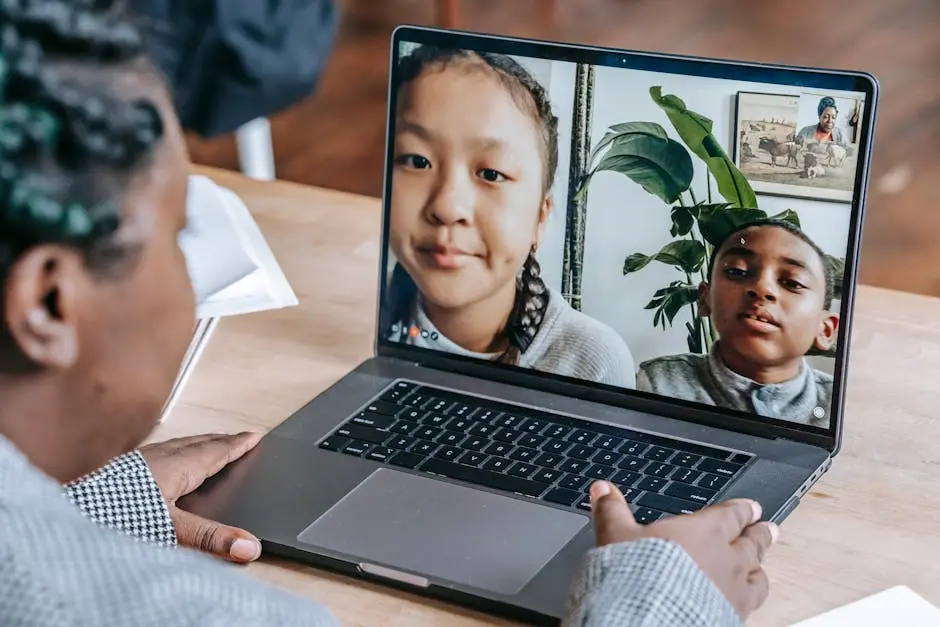 A teacher holding an online class with diverse students through a laptop during a distance learning session.