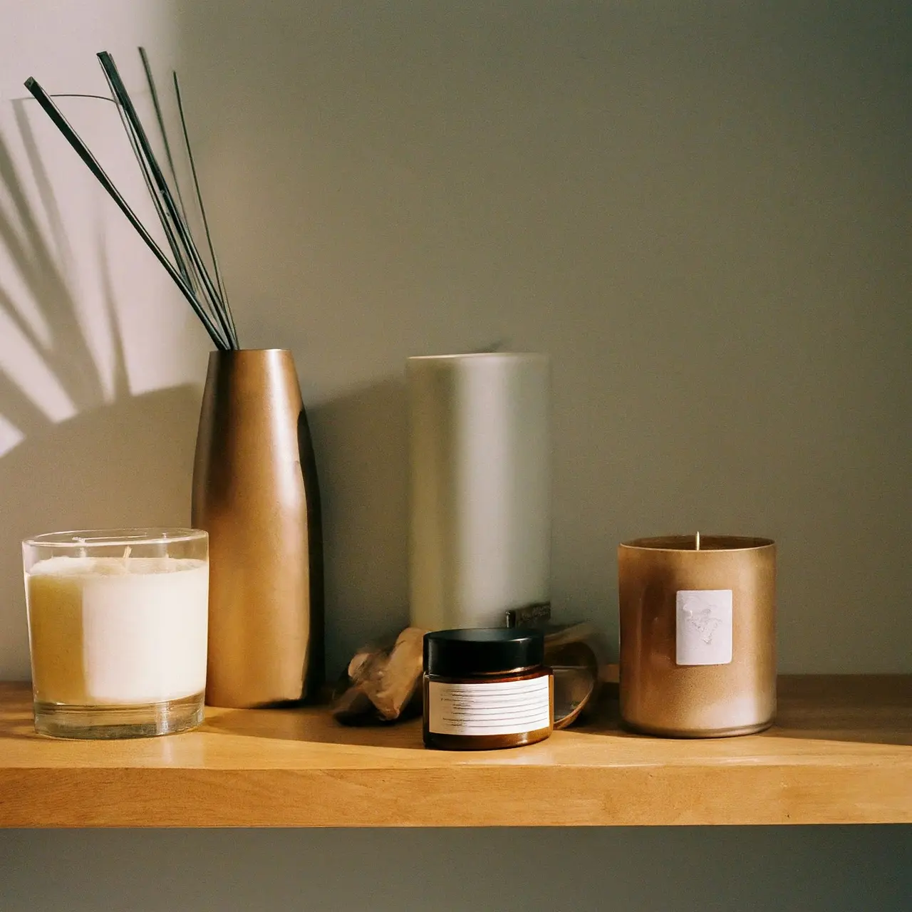 A variety of scented candles on a wooden shelf. 35mm stock photo