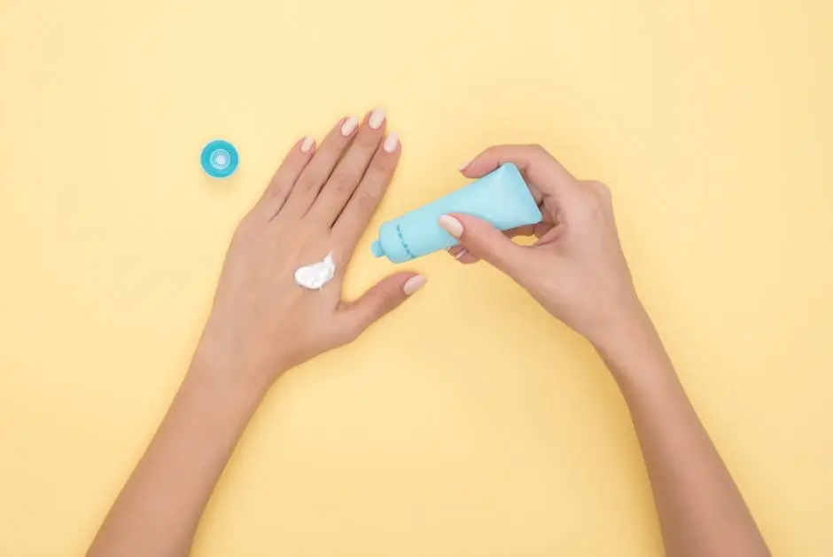 Close-up of a woman’s hands applying cream on a pastel yellow background. Ideal for beauty and skincare themes.