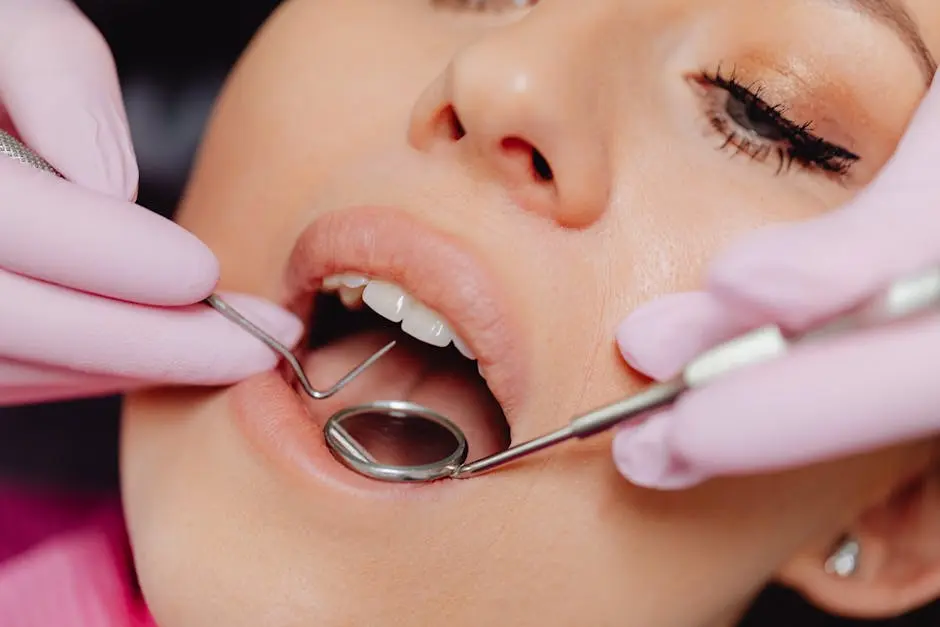 Close-up of a woman’s dental checkup with a dentist using tools in a clinic.