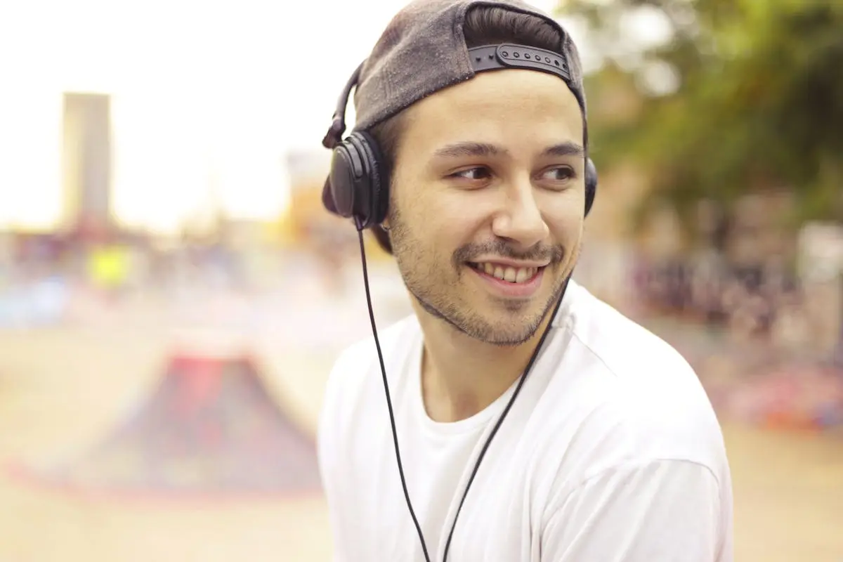 Man in White Crew Neck Shirt Wearing Black Headphones