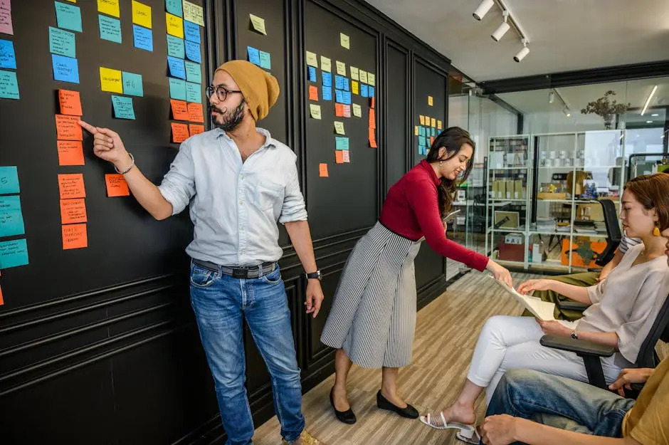 Team members collaborating in a modern office with sticky notes on a wall, focusing on brainstorming and strategy.