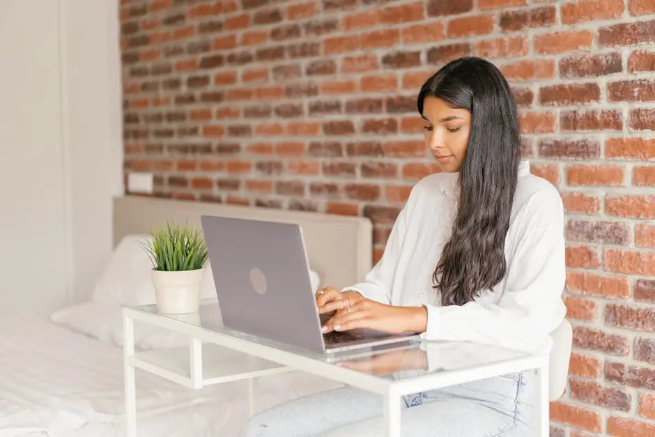 A Woman in White Long Sleeve Shirt Using a Laptop