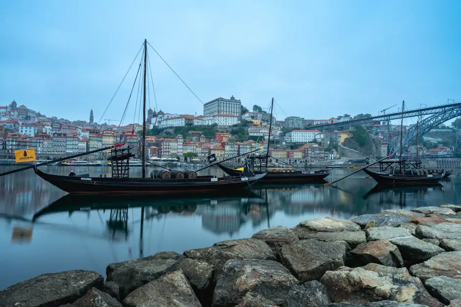 Traditional rabelo boats on the Douro River with Porto's picturesque waterfront.