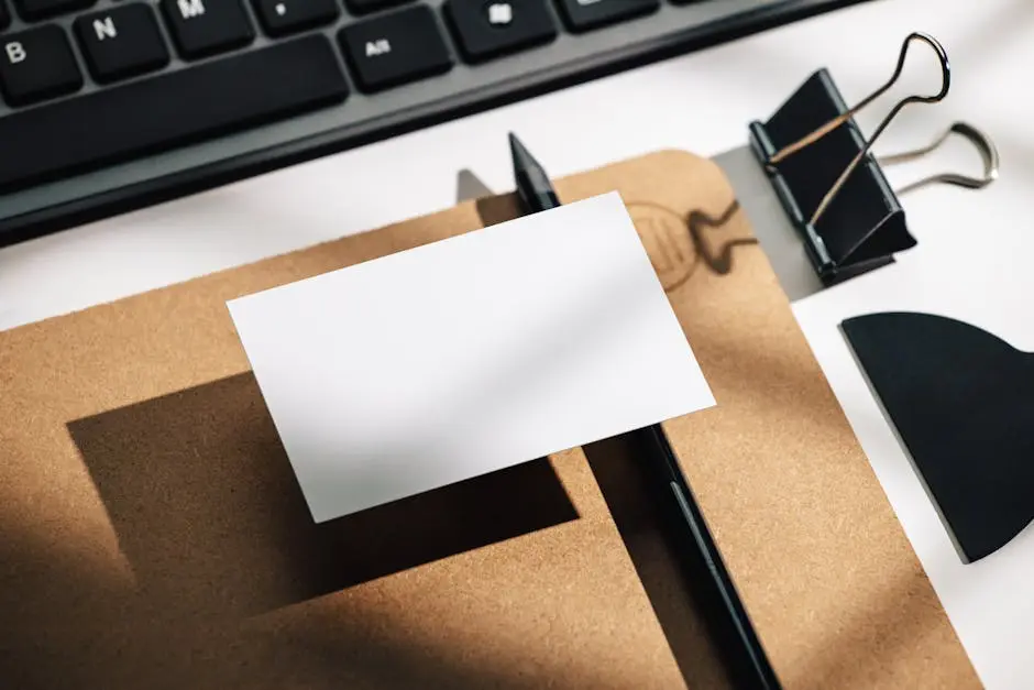 Photo of a Small White Sheet of Paper, Stationery and a Keyboard