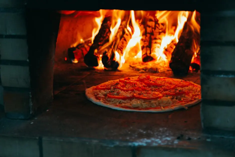 Close-up of a pizza baking in a traditional wood-fired brick oven with flames.