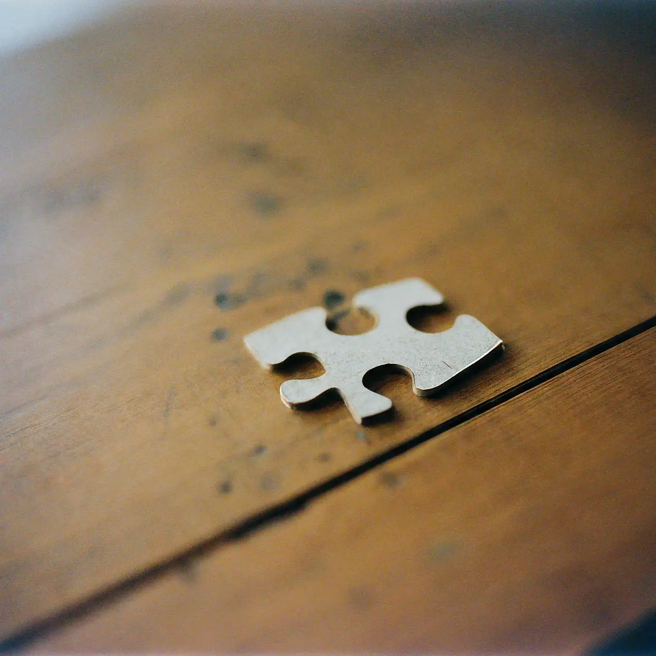 A puzzle piece completing a larger puzzle. 35mm stock photo