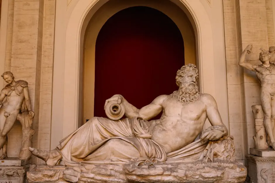 Elegant marble statues in a Vatican City gallery displaying Greek-Roman art.