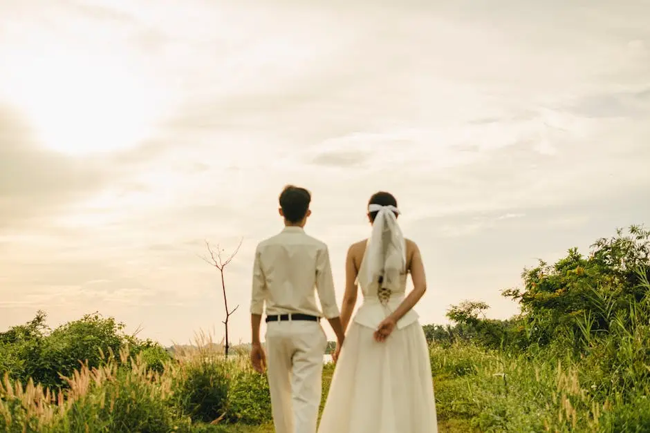 Married Couple Walking on a Field Holding Hands