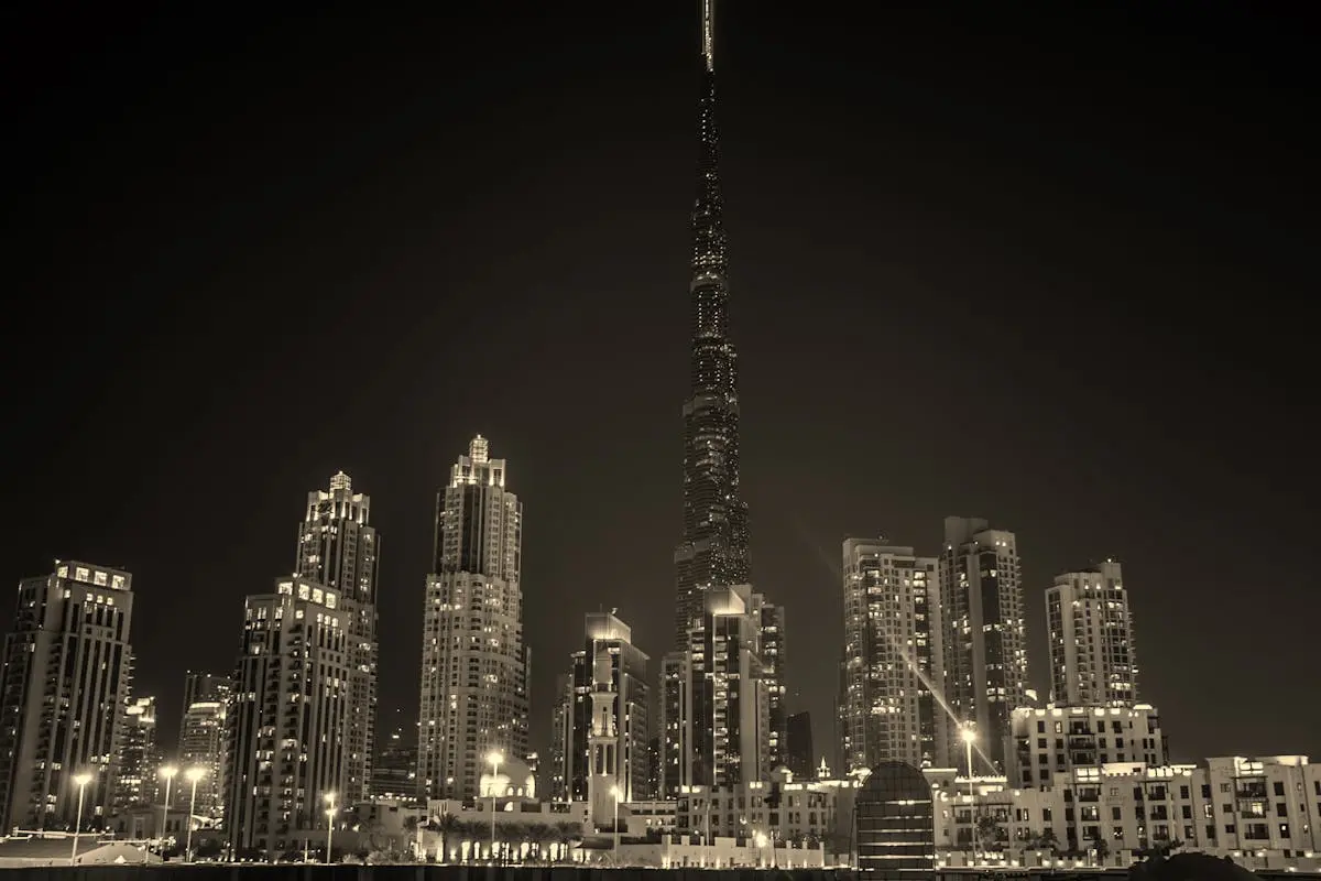 Captivating black and white night view of Dubai’s skyline with the iconic Burj Khalifa illuminated.