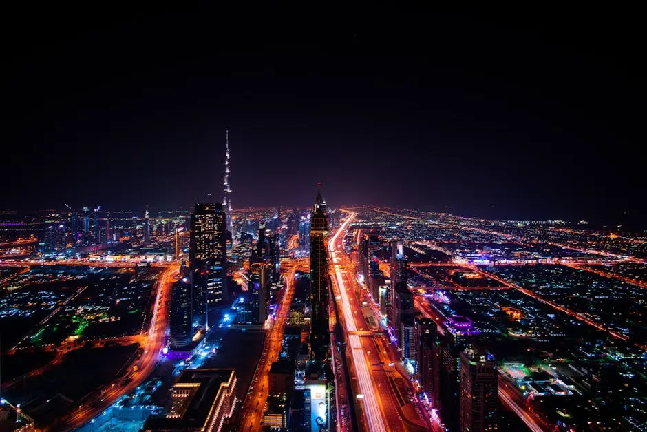 A breathtaking aerial view of Dubai’s cityscape at night, highlighting the illuminated Burj Khalifa and surrounding skyscrapers.