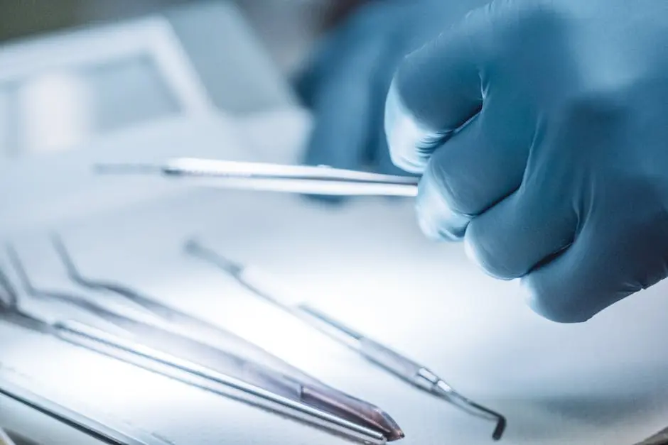 Close-up of a surgeon’s gloved hand holding surgical instruments in a sterile setting.