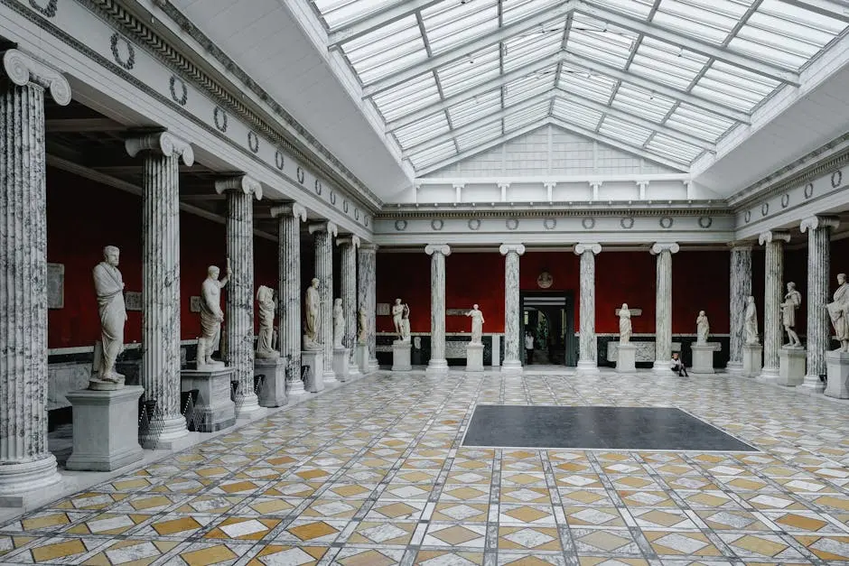 Beautiful classical statues in a historic art museum with ornate columns in Copenhagen, Denmark.