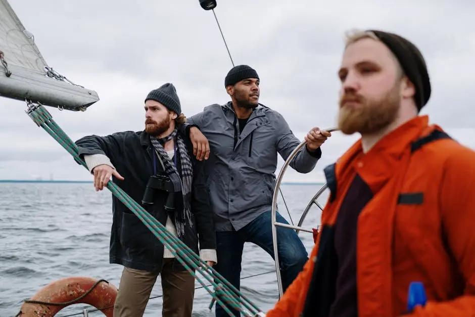 Three men sailing on a boat, showcasing adventure and teamwork on open waters.