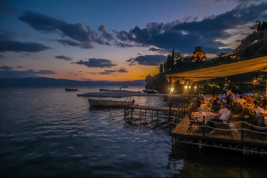 People In A Restaurant Beside Body Of Water