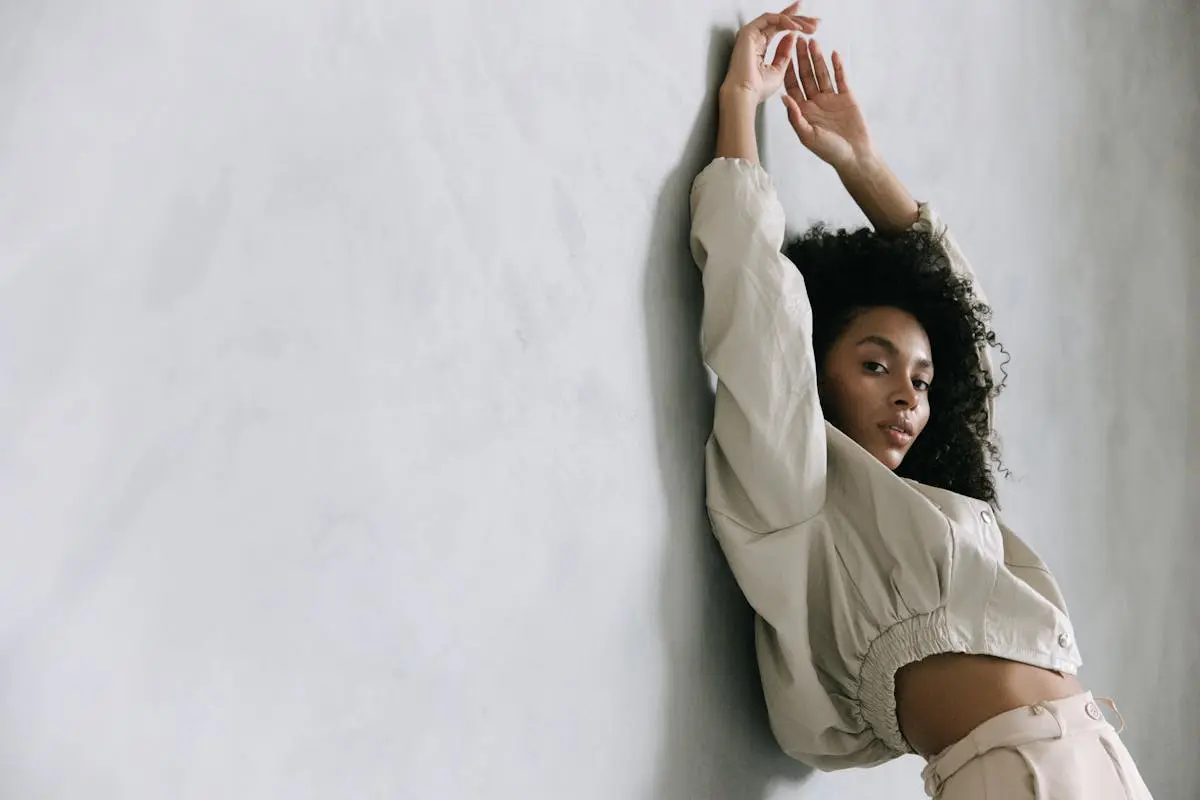 Woman in White Cropped Jacket Leaning on Wall