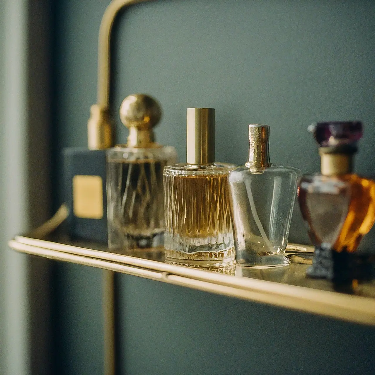 A collection of different perfume bottles on a stylish shelf. 35mm stock photo