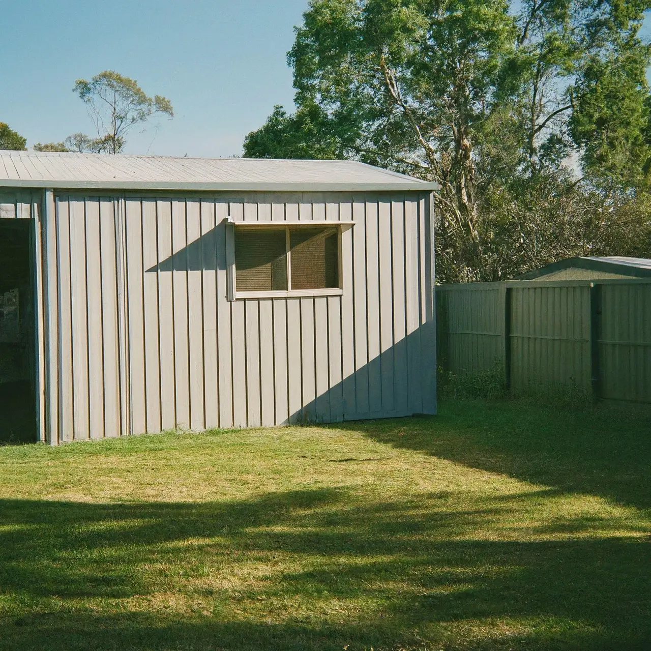 A Colorbond shed in a sunny Sydney backyard. 35mm stock photo