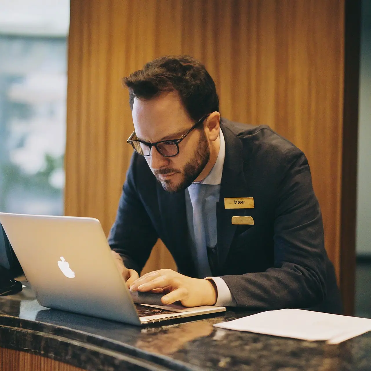 A hotel manager reviewing guest feedback on a laptop. 35mm stock photo